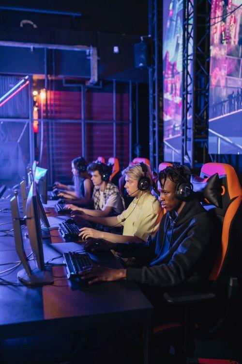 A row of players at a LAN event, each at a monitor in headsets